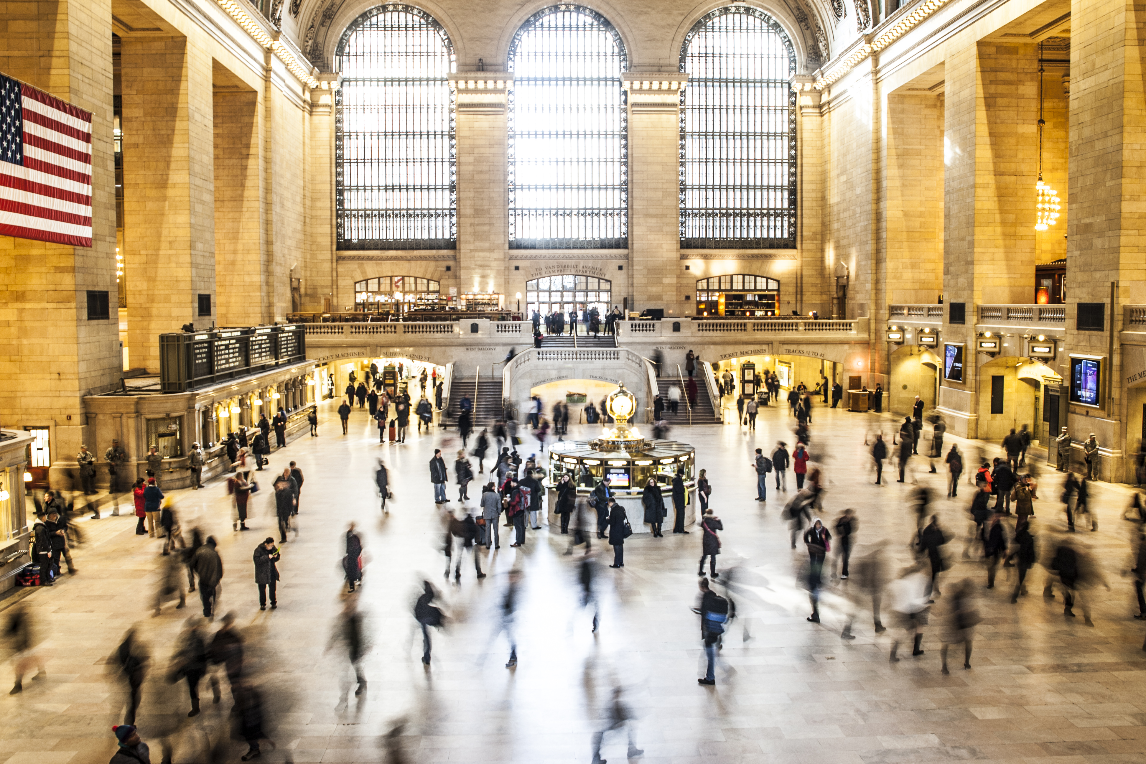Crowds walking in a New York train station after the economic recovery from COVID-19